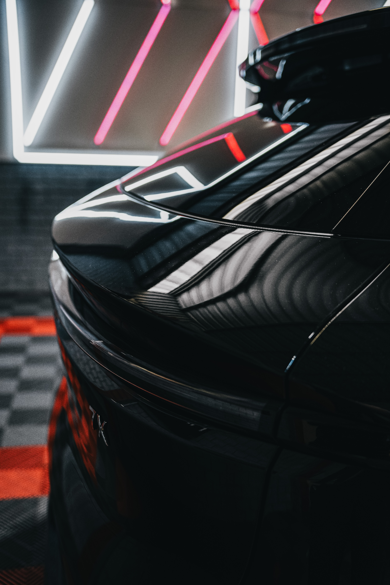 Black sports car rear spoiler reflections
