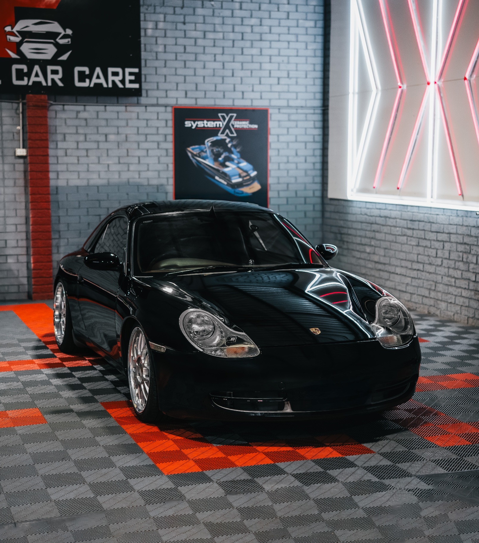 Black Porsche 911 inside Final Car Care studio