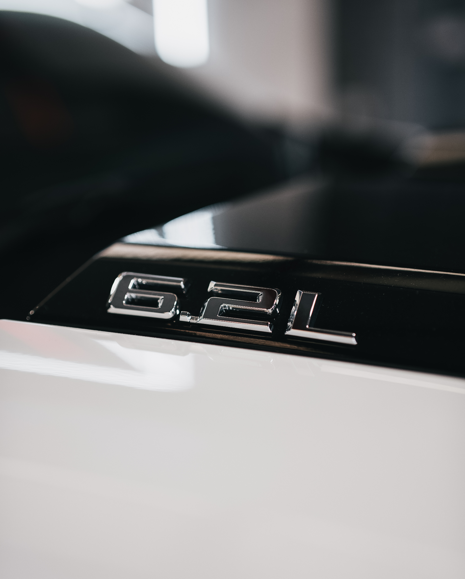 6.2L badge close-up on white truck