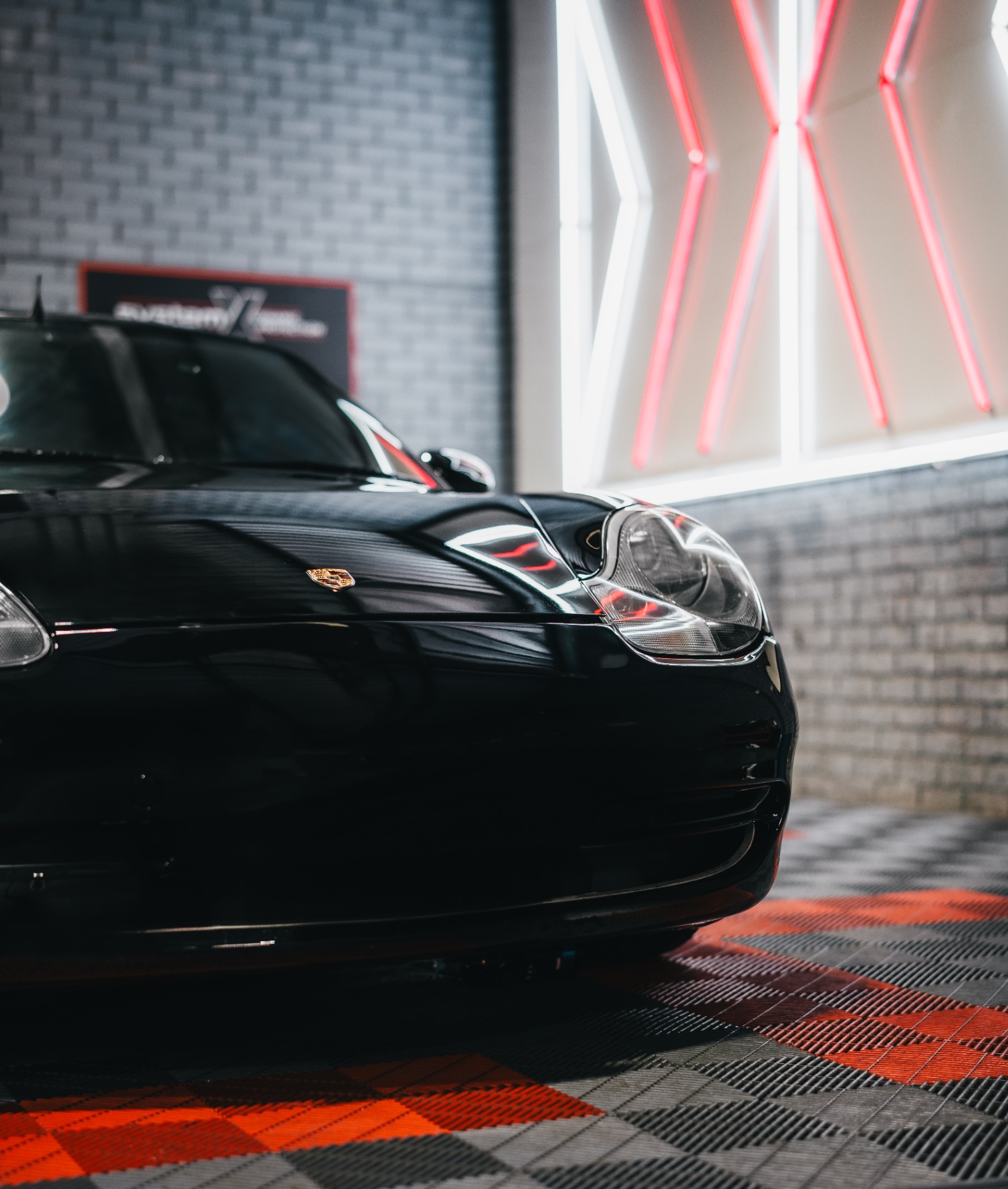 Black Porsche 911 front under studio lighting